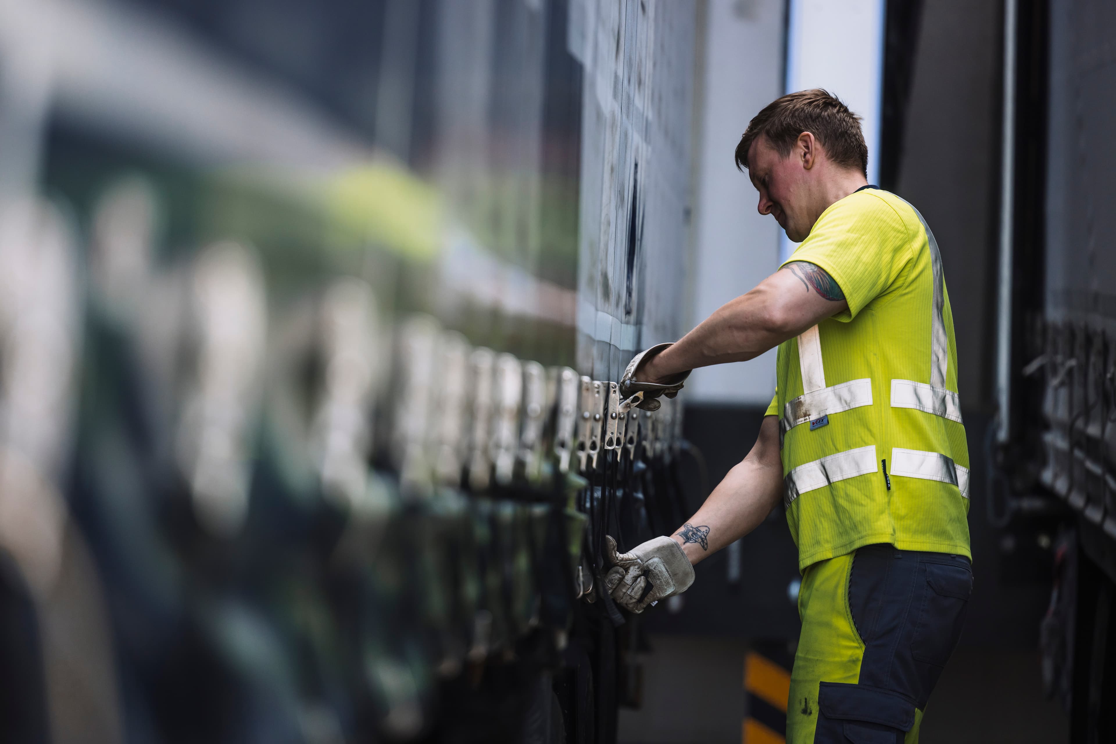 Driver closing the truck tarpaulin
