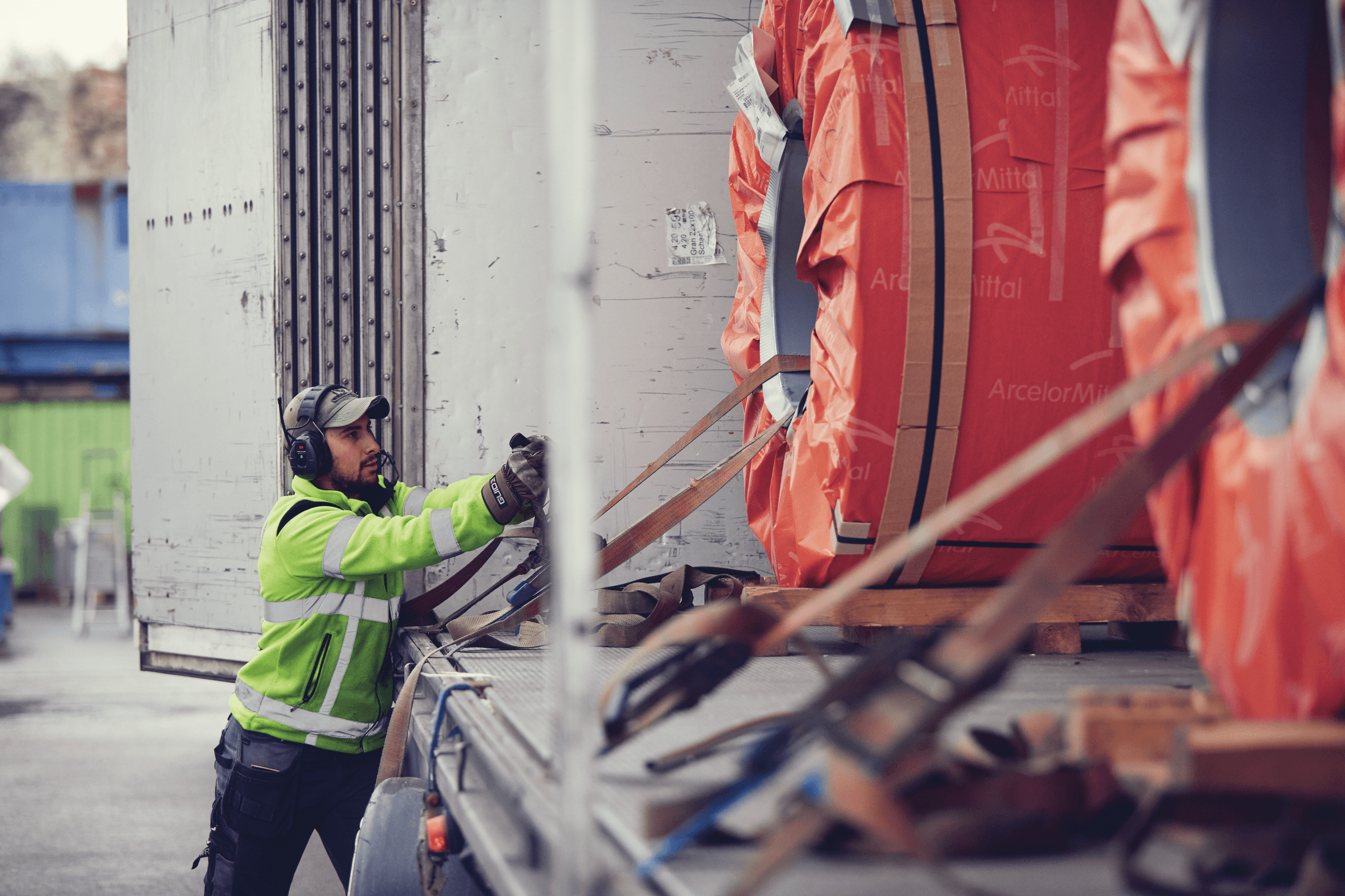 A DFDS employee loading steel coils on a DFDS Logistics truck in Gothenburg